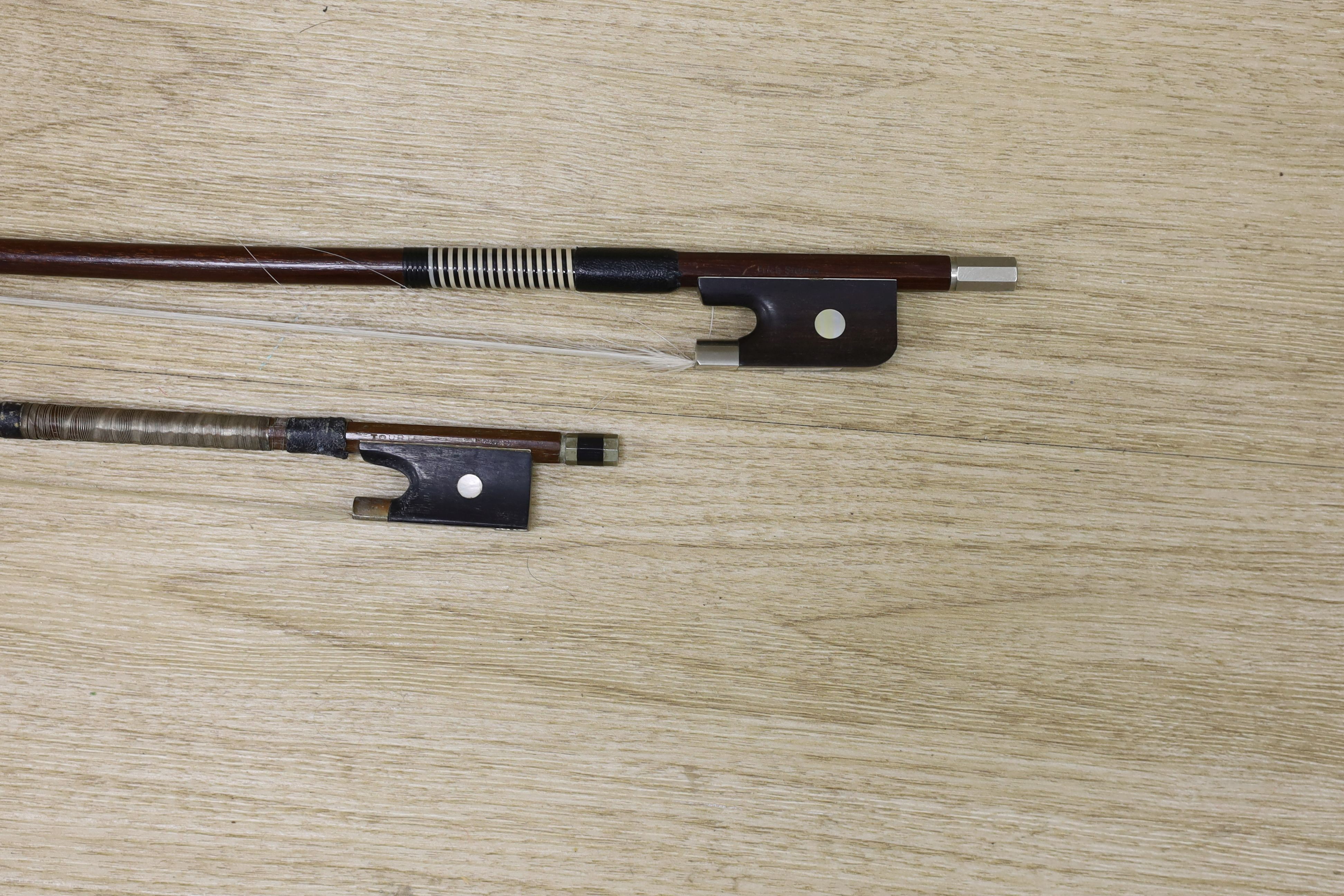 Two violin bows, signed Erich Steiner and Tourte, 73 cms long.